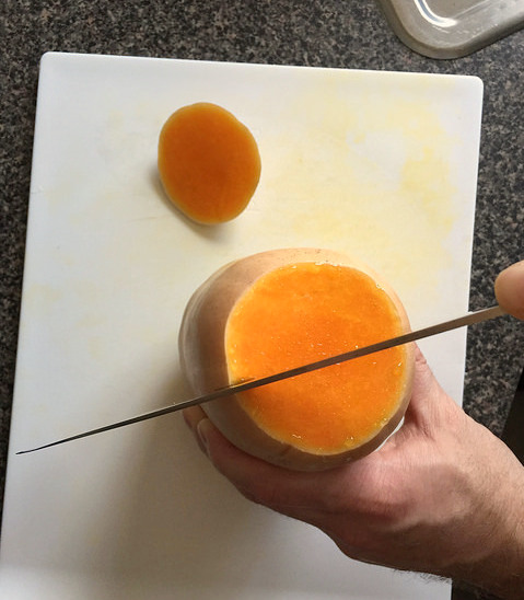 "Oven-roasted butternut squash halves -- slice in half, scoop out seeds, brush with oil, place face down on baking tray, and bake